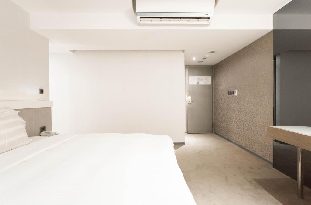 Postel nebo postele na pokoji v ubytování Saual Keh Hotel