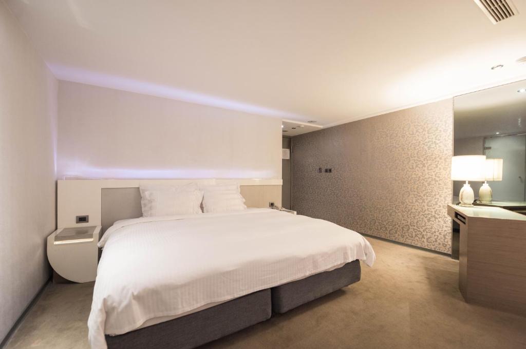 Postel nebo postele na pokoji v ubytování Saual Keh Hotel