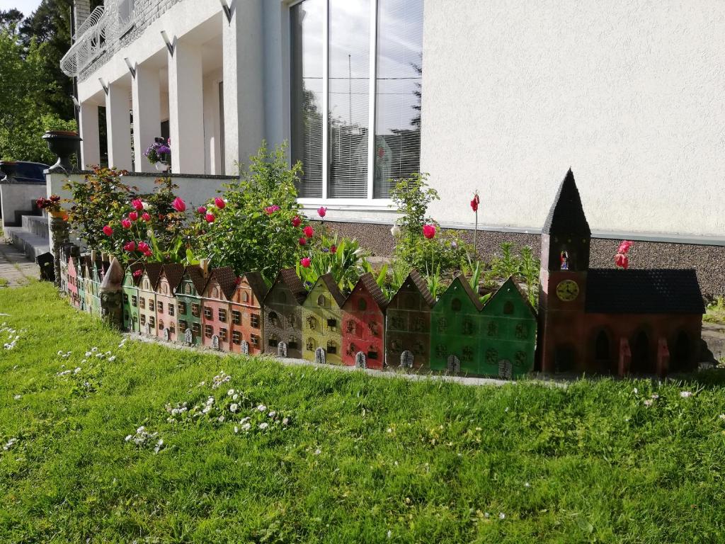 a model of a house with flowers in a yard at Oti Guesthouse in Tallinn
