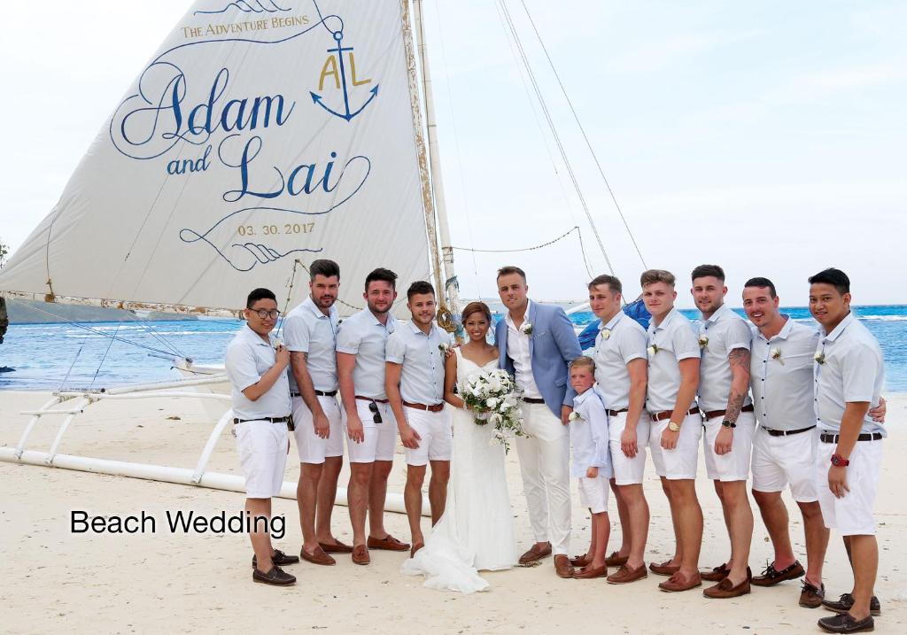 a bride and groom and their wedding party on a sailboat at Fairways and Bluewater Boracay in Boracay