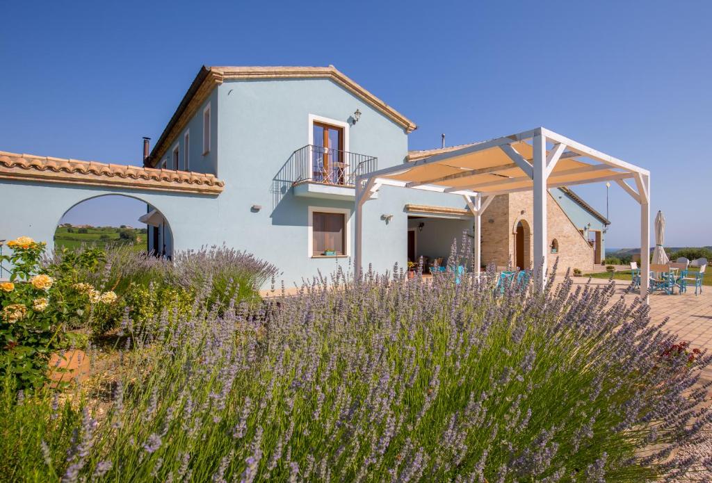 a house in the middle of a field of flowers at Relais Piano Valle in Pollutri