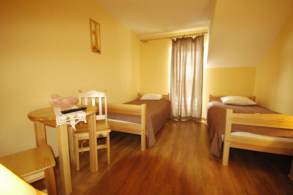 Postel nebo postele na pokoji v ubytování Szeptucha