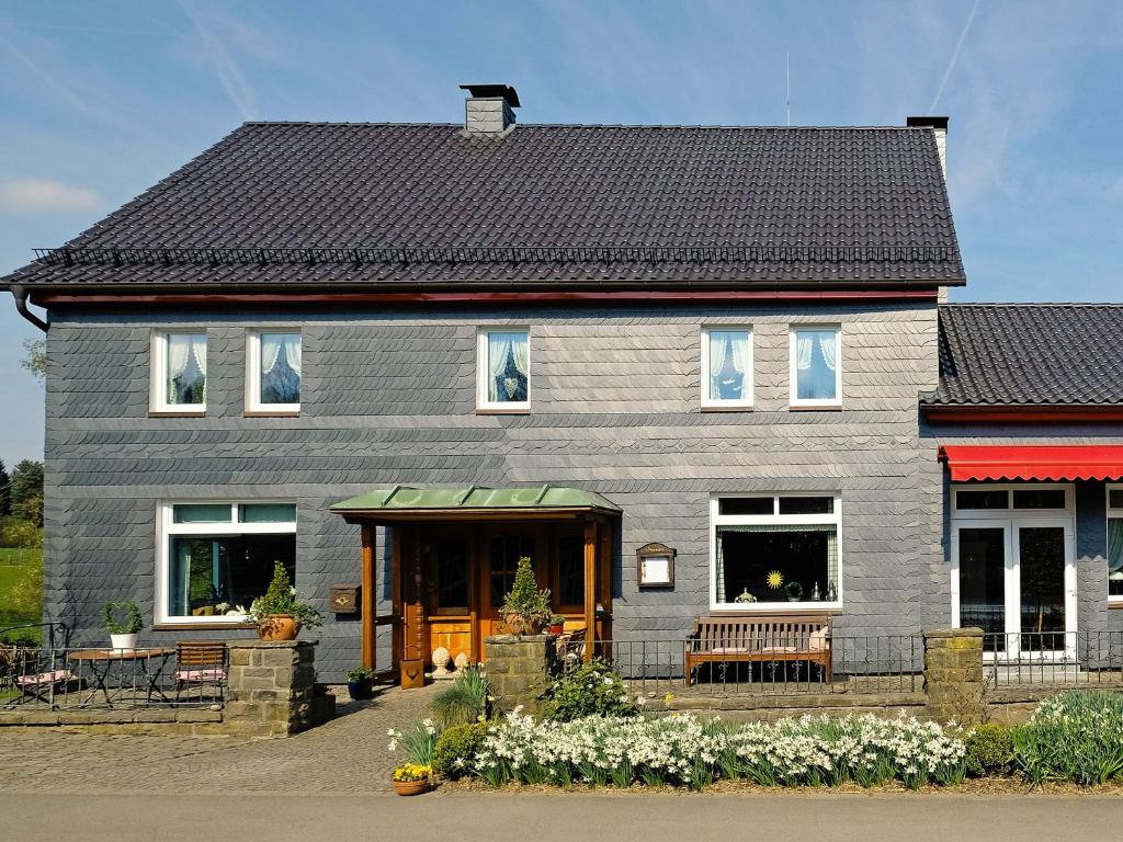 a gray house with a black roof at Stöltings Landhaus in Wiehl