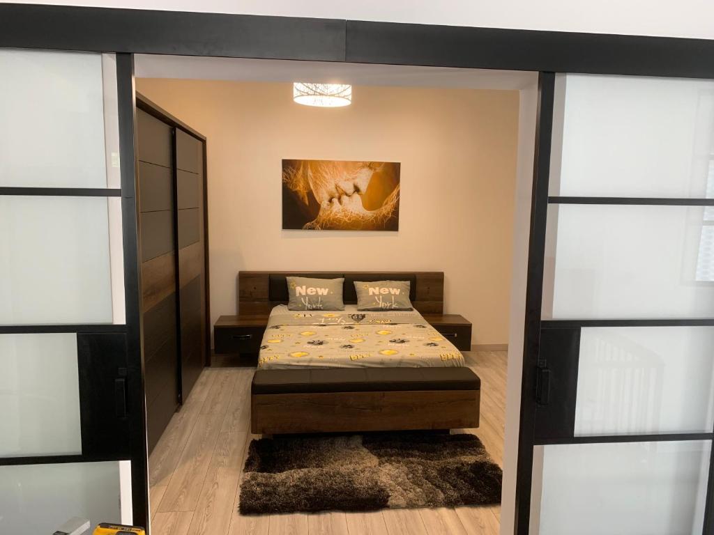 a bedroom with a bed and some sliding glass doors at Manifique Maison T2 50m2 Atypique wifi & parking privée in Oullins