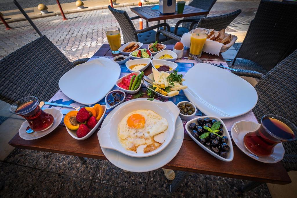 a table with breakfast foods and drinks on it at Villa Vongole in Çeşme