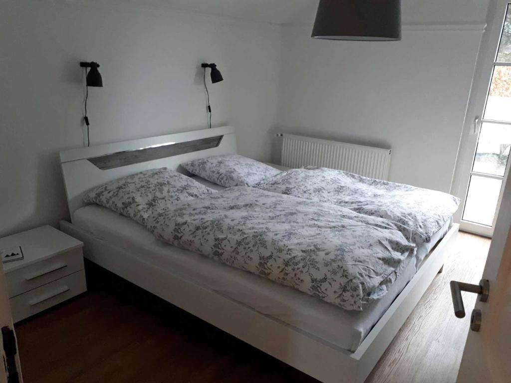 a bedroom with a bed with a white comforter at Sissi's Feriendomizil in Winterberg