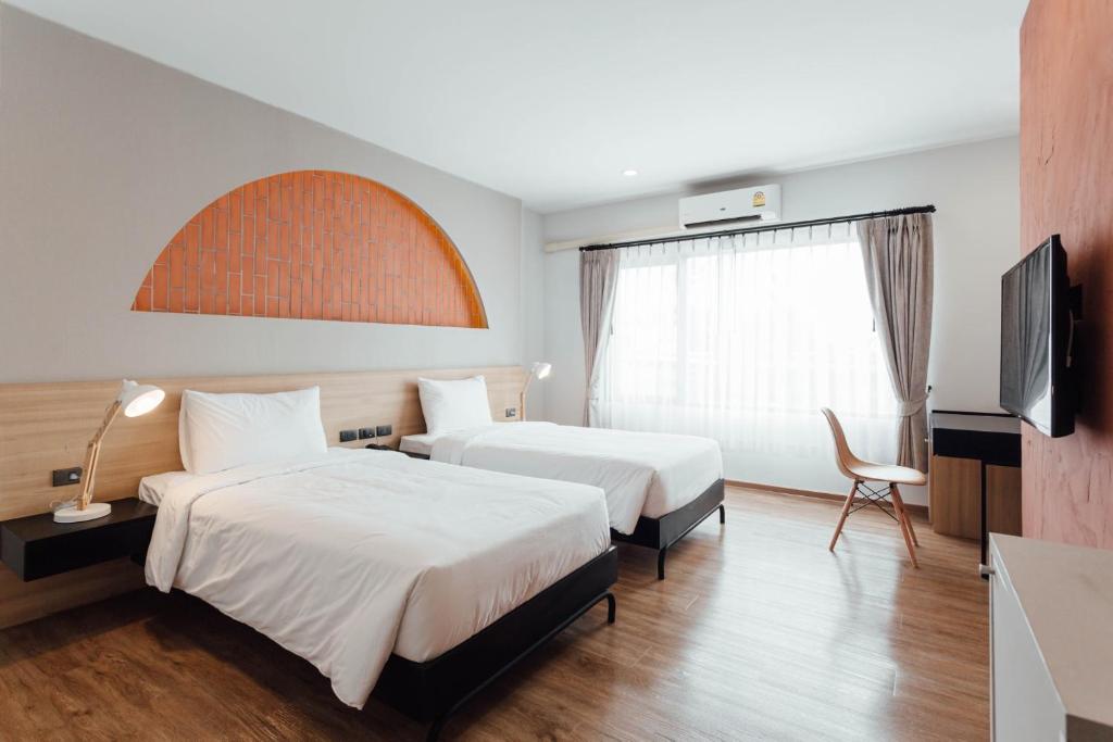 Postel nebo postele na pokoji v ubytování Clay Hotel Udonthani