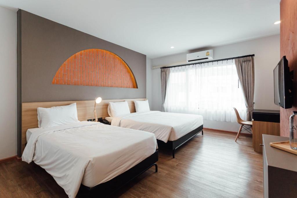 Postel nebo postele na pokoji v ubytování Clay Hotel Udonthani