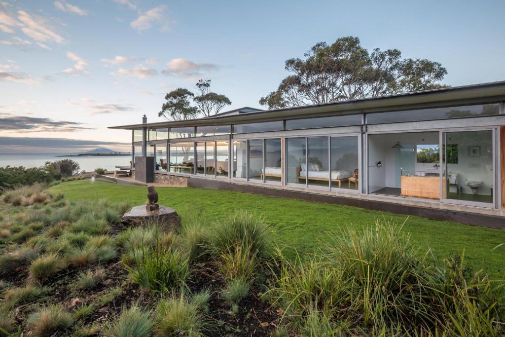 a house on a hill with a view of the ocean at Avalon Coastal Retreat in Swansea