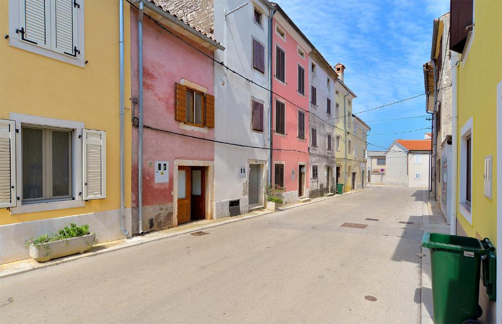 an empty street in a town with colorful buildings at House Silvo 1953 in Vodnjan