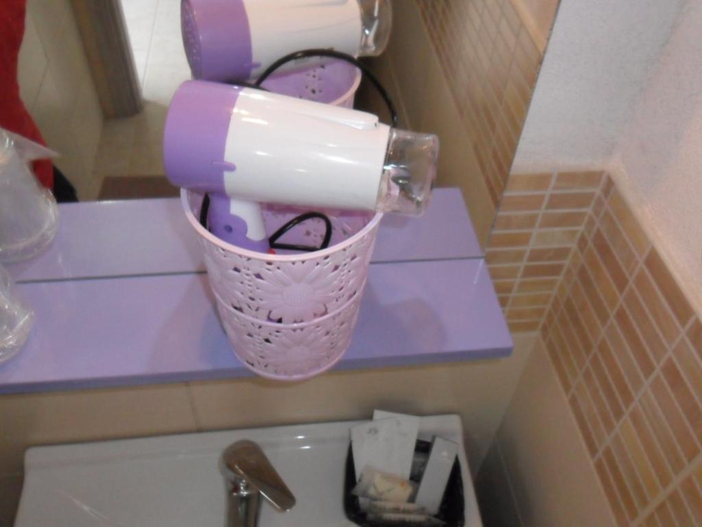 a cup on top of a sink in a bathroom at agriturismo heaven in Capo Vaticano