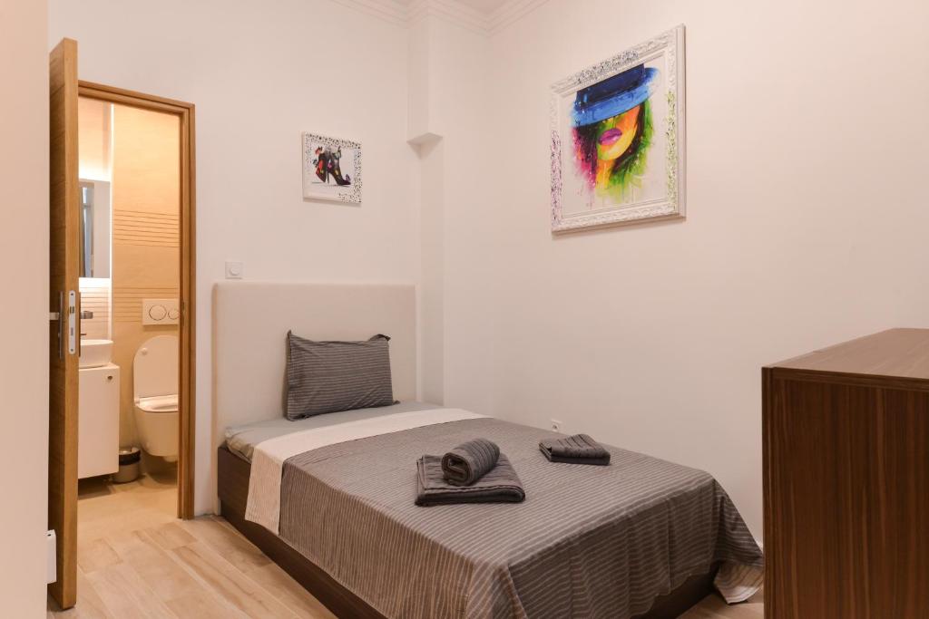 a small bedroom with a bed and a bathroom at CACAO Studio next to Crystal Garden and Russian Church in Sofia