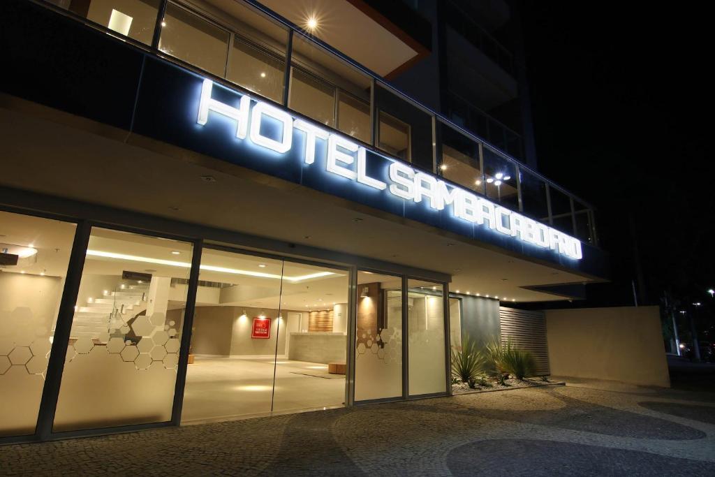 a building with a neon sign on the side of it at Samba Cabo Frio in Cabo Frio