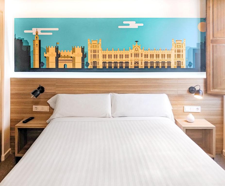 a bedroom with a bed with a painting of a building at Original Domino House in Valencia