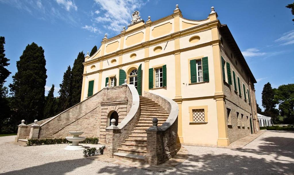 a large building with stairs in front of it at Villa Rinalducci in Fano
