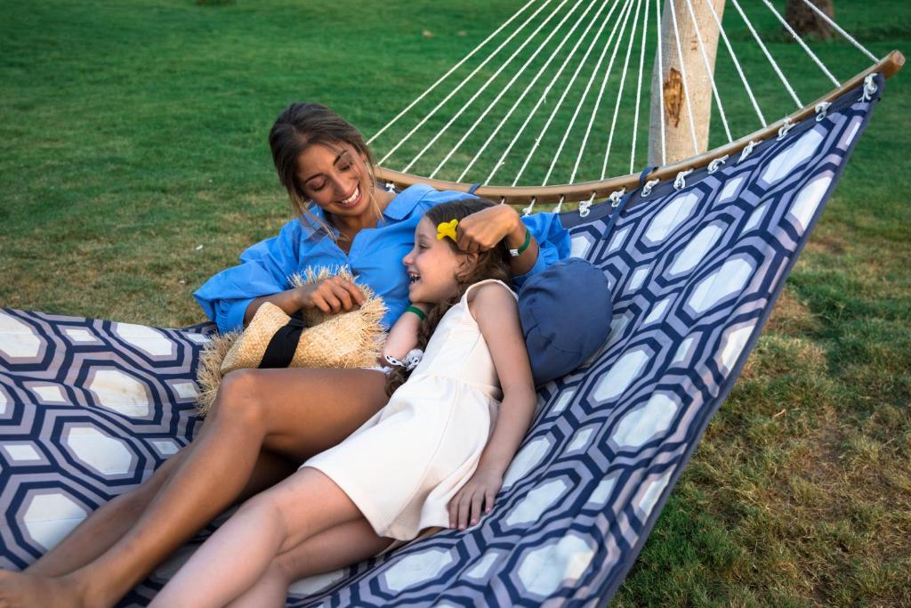 a woman and a little girl laying on a hammock at Desert Rose Resort in Hurghada