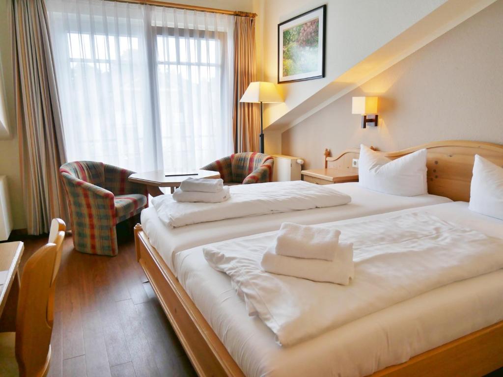 Postel nebo postele na pokoji v ubytování R&R Hotel Strandallee