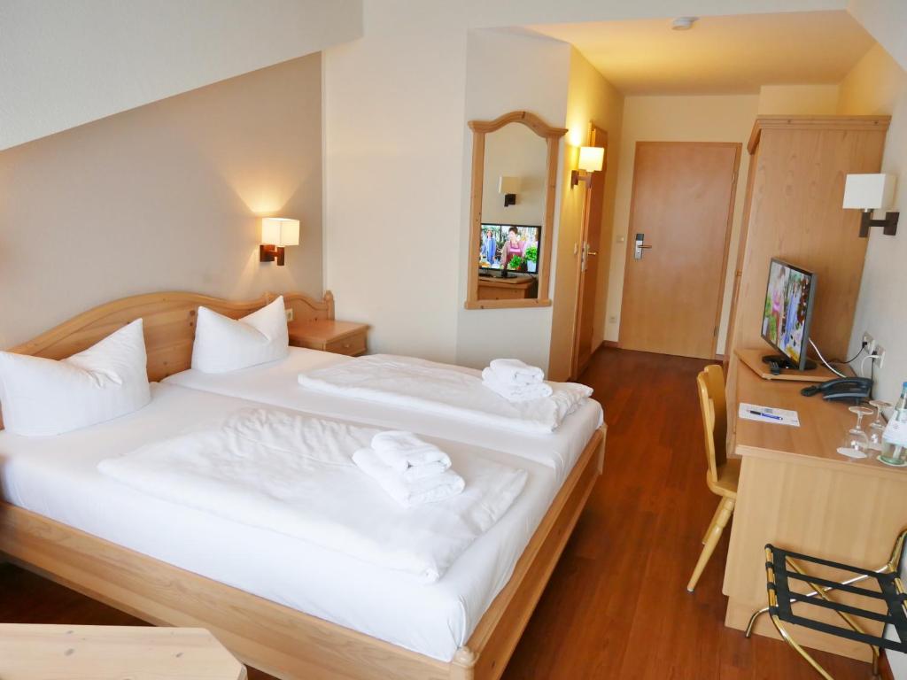 Postel nebo postele na pokoji v ubytování R&R Hotel Strandallee