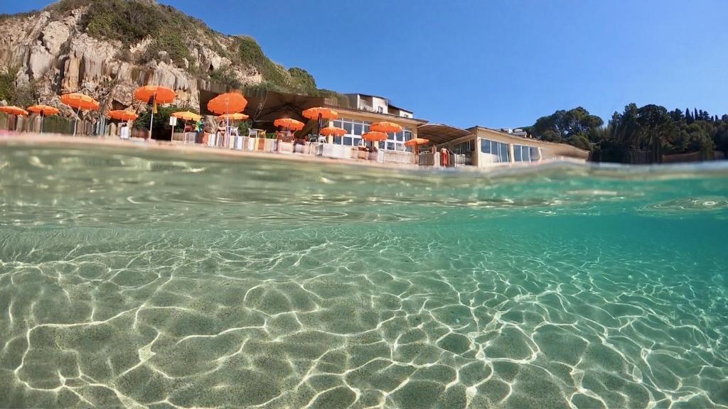 a view of the water in front of a resort at Hôtel Sampiero Corso in Propriano