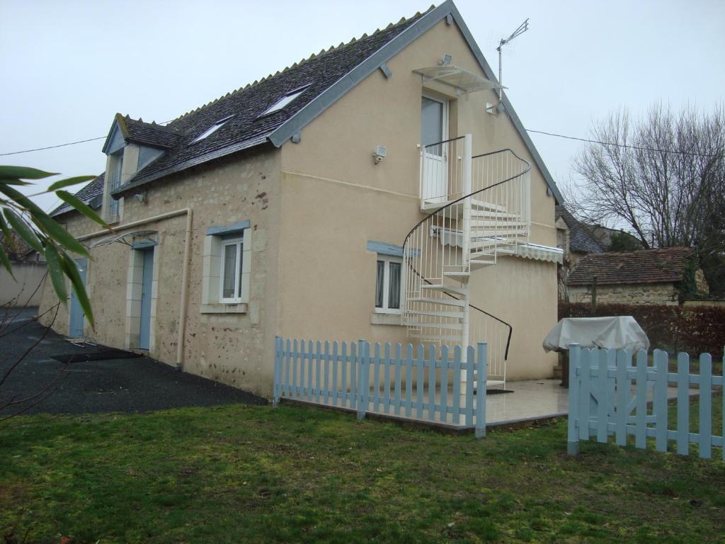 a house with a blue fence in front of it at le four à pain in Faverolles