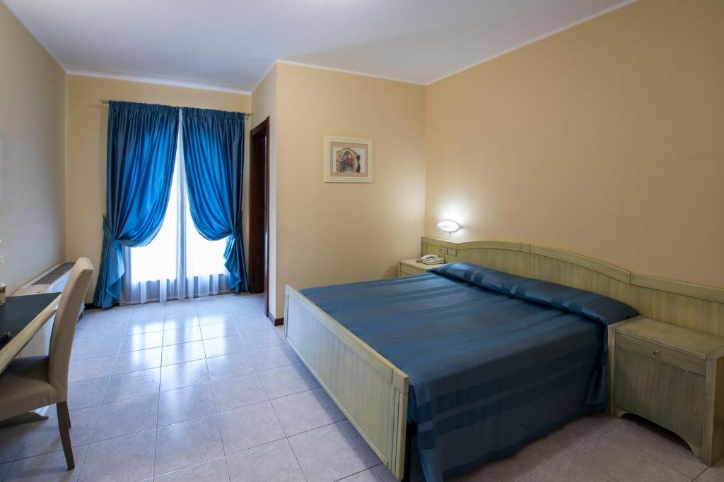 Postel nebo postele na pokoji v ubytování Hotel Cristoforo Colombo
