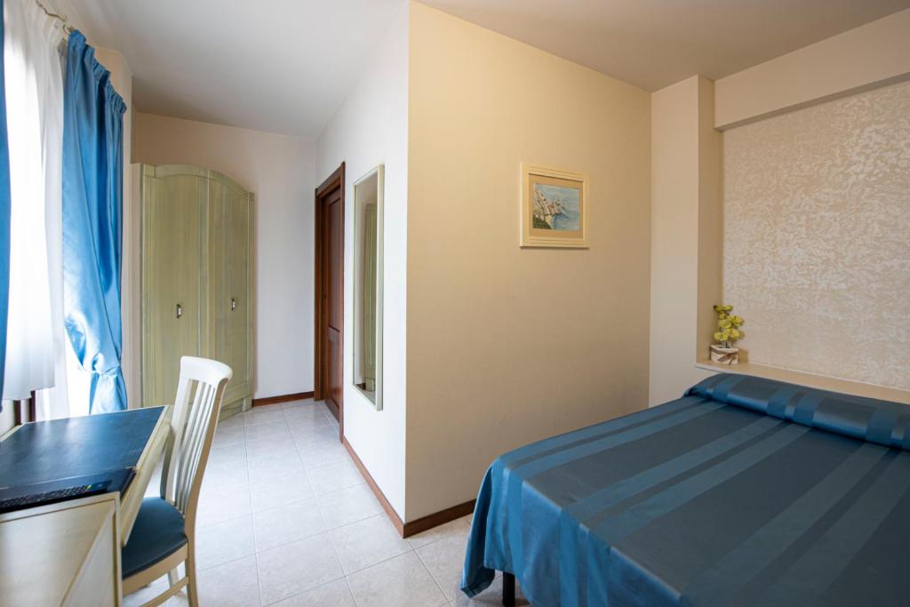 Postel nebo postele na pokoji v ubytování Hotel Cristoforo Colombo