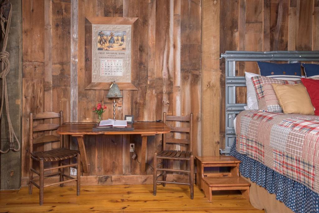 a bedroom with a table and chairs and a bed at 7F Lodge and Events in College Station