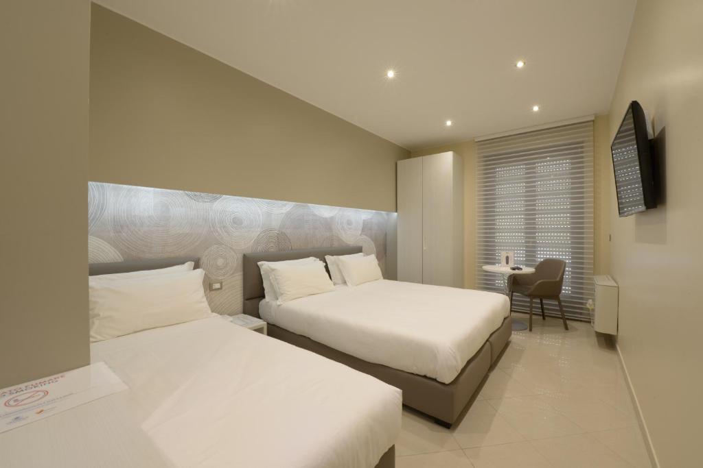 Postel nebo postele na pokoji v ubytování Imperiali Hotel