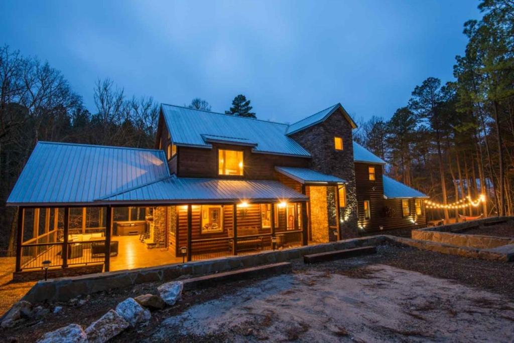 a log home with a blue roof and a yard at Indian Springs Lodge-Game Room, Video Game Table in Stephens Gap
