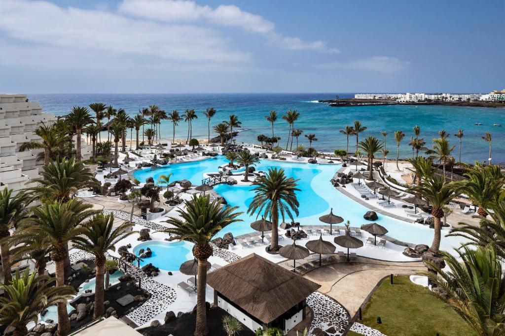 an aerial view of a resort with a pool and the ocean at Paradisus by Meliá Salinas Lanzarote - All Inclusive - Adults Only in Costa Teguise