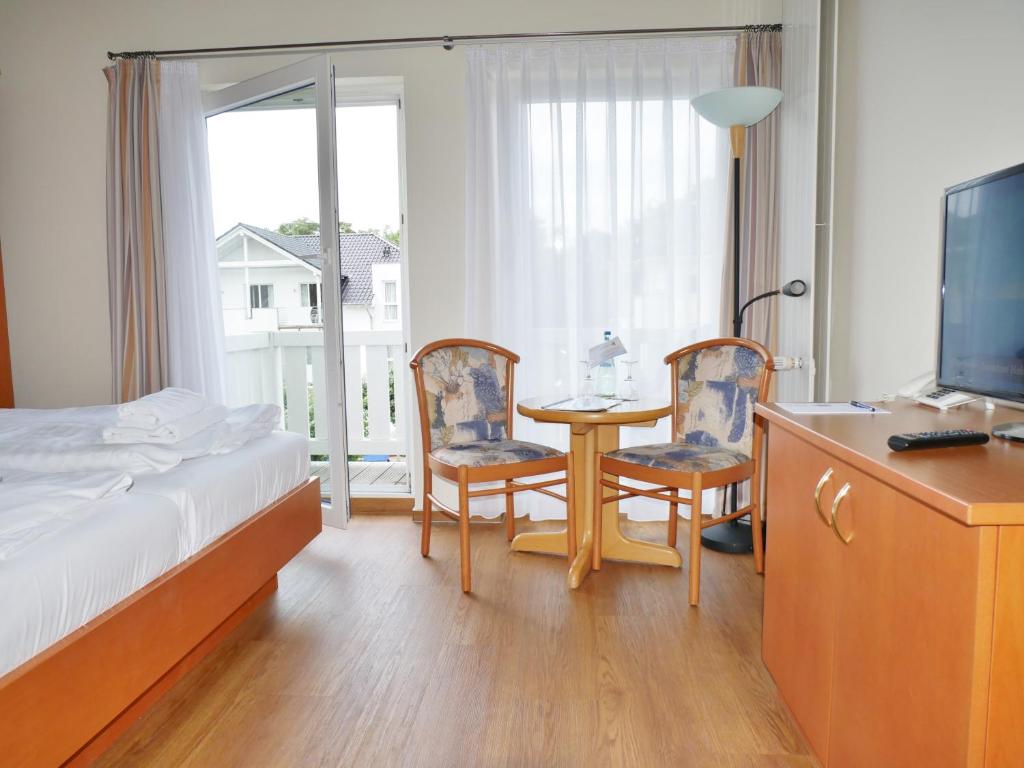 Postel nebo postele na pokoji v ubytování R&R Hotel Strandallee