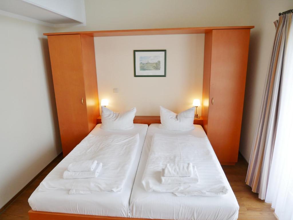 Postel nebo postele na pokoji v ubytování R&R Hotel Strandallee
