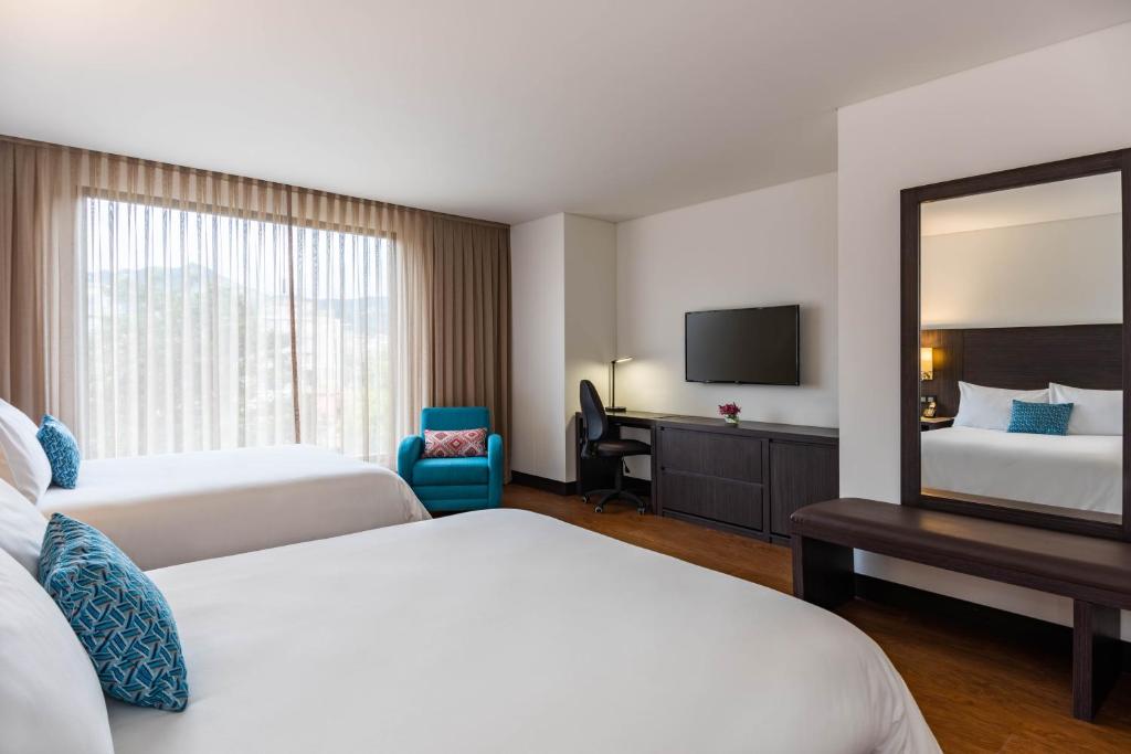 Postel nebo postele na pokoji v ubytování Hotel Morrison Usaquén