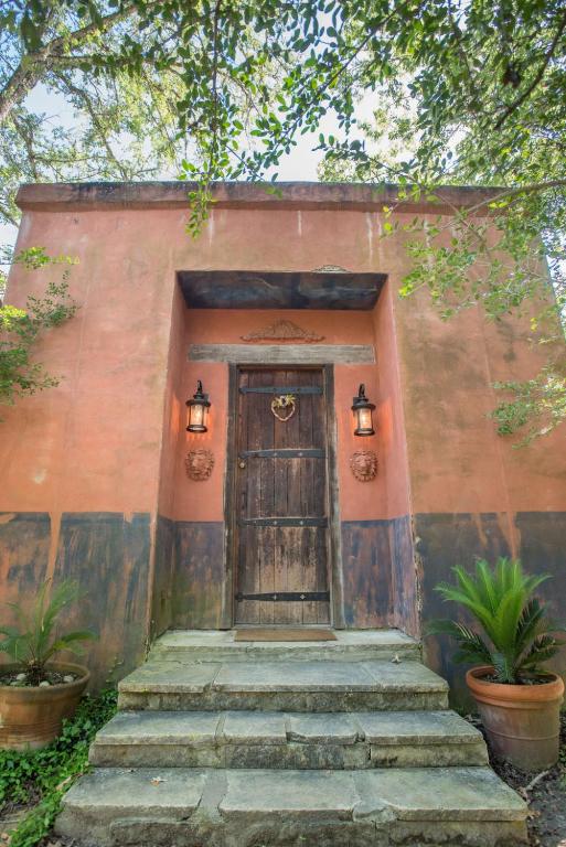 a building with a wooden door and some stairs at 7F Lodge and Events in College Station