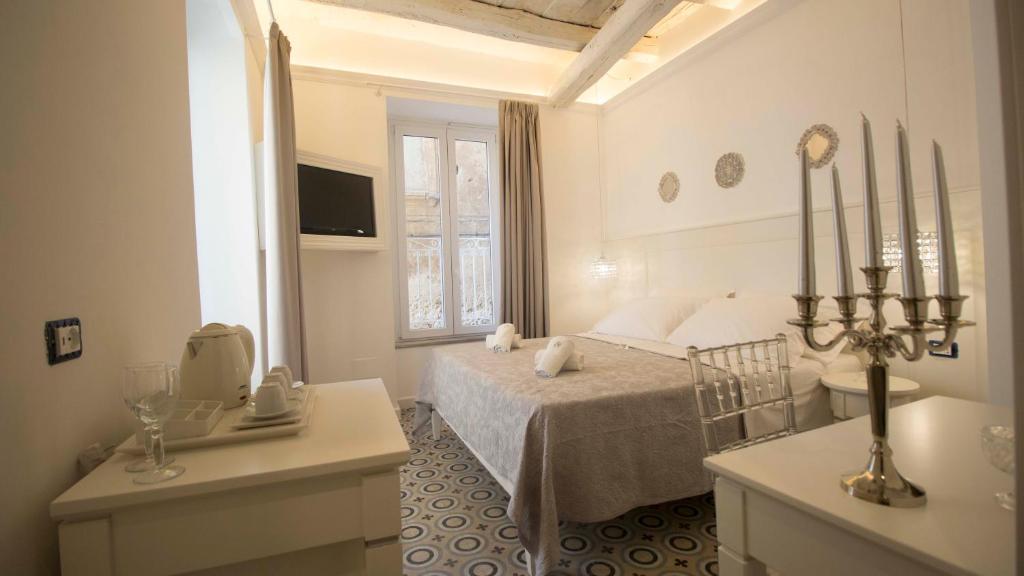 a white bedroom with a bed and a sink at BellaVita accomodation in Tropea