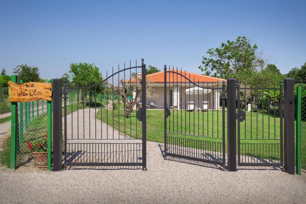 a gate at a park with a playground at B&B I Tre Olivi in Colà di Lazise