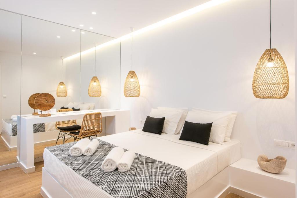 um quarto branco com uma cama e uma secretária em Matala Luxury Apartments em Matala