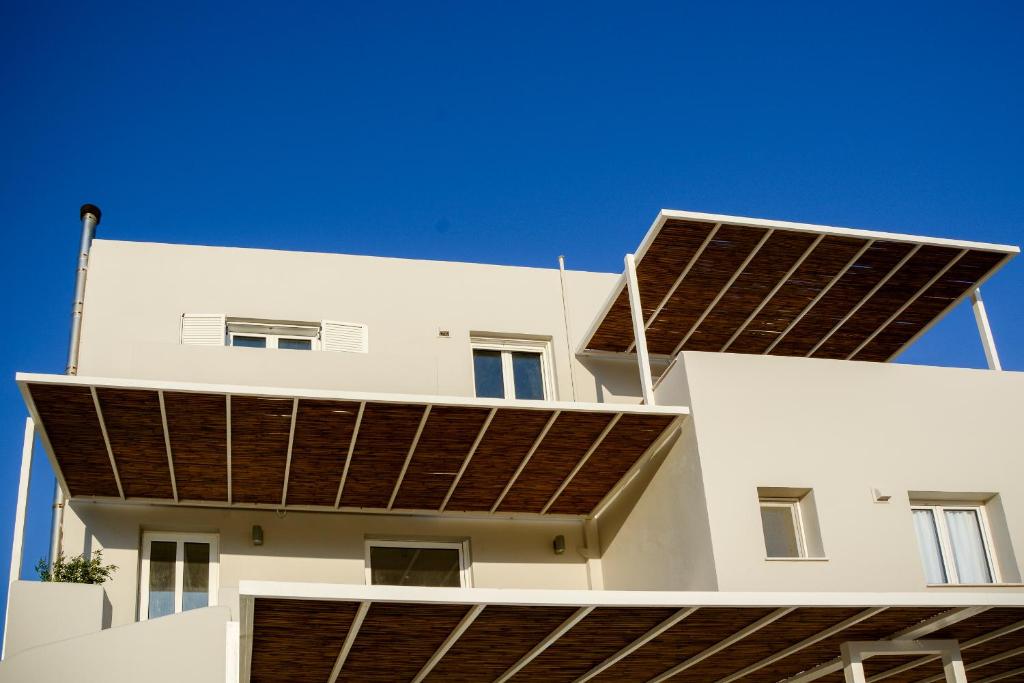 a building with a lot of solar panels on it at Pharos Apartments in Gavrio