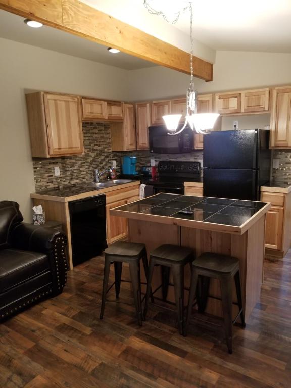 a kitchen with a large island with bar stools at Downtown Cheyenne in Cheyenne
