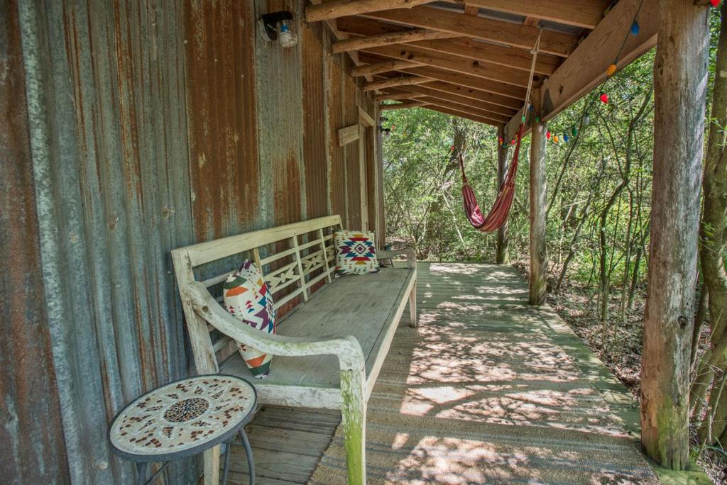 a bench sitting on the porch of a house at 7F Lodge and Events in College Station