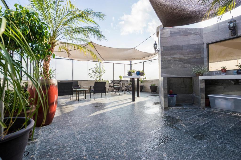 an outdoor patio with plants and a fireplace at Air Lux in Mexico City