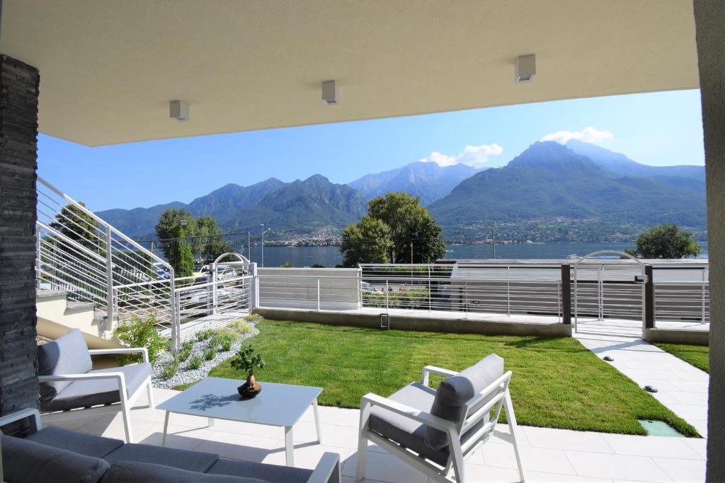 a patio with a view of the mountains at Appartamento Fiordaliso Bellagio Wild Flowers - HOT TUB in Onno