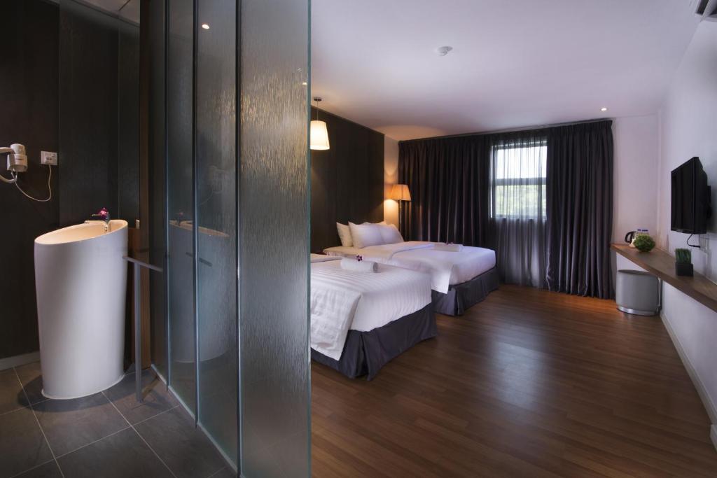 Postel nebo postele na pokoji v ubytování T+ Hotel Butterworth