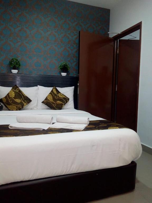 Postel nebo postele na pokoji v ubytování D'Metro Hotel
