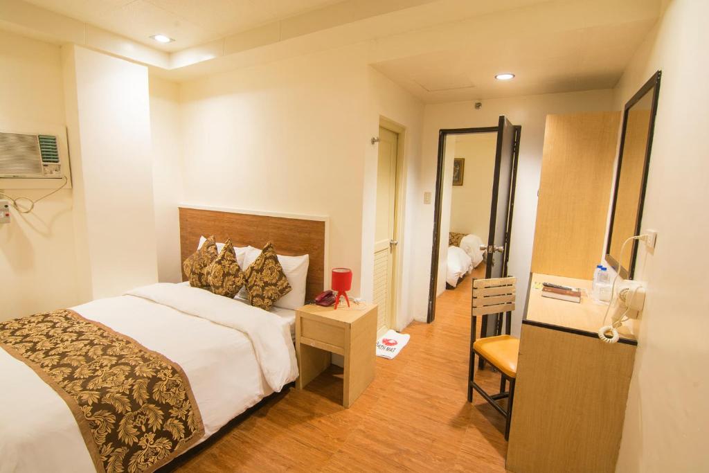 Postel nebo postele na pokoji v ubytování Hotel Carmelita