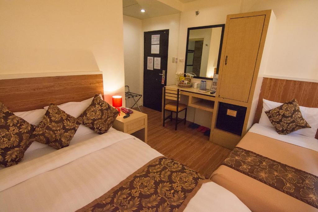 Postel nebo postele na pokoji v ubytování Hotel Carmelita