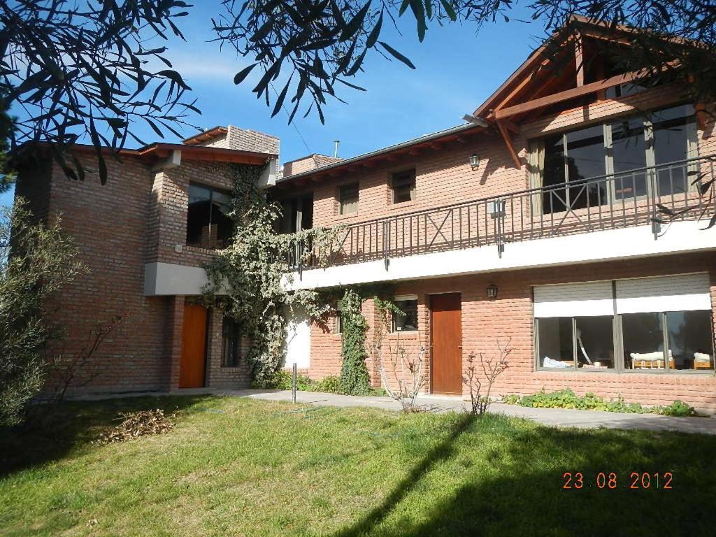 a brick house with a balcony on the side of it at Complejo Duque in Puerto Madryn