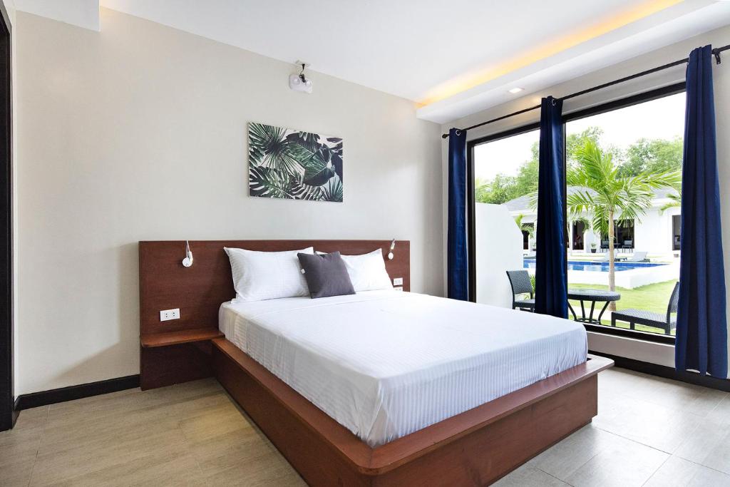 Postel nebo postele na pokoji v ubytování OHANA, Panglao Resort.