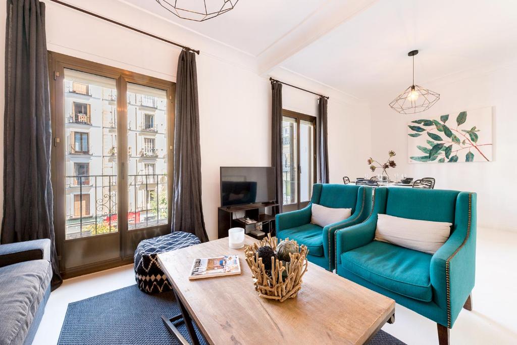 a living room with a couch and a table at Genteel Home Chueca in Madrid