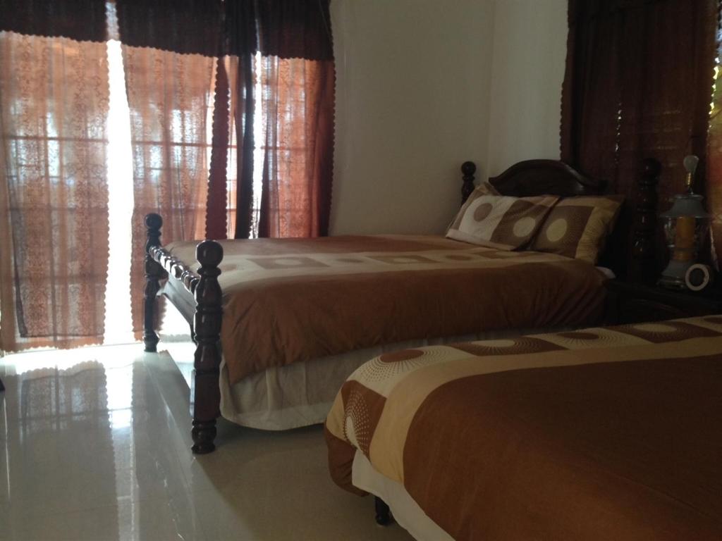 Ένα ή περισσότερα κρεβάτια σε δωμάτιο στο My-Places Montego Bay Vacation Home